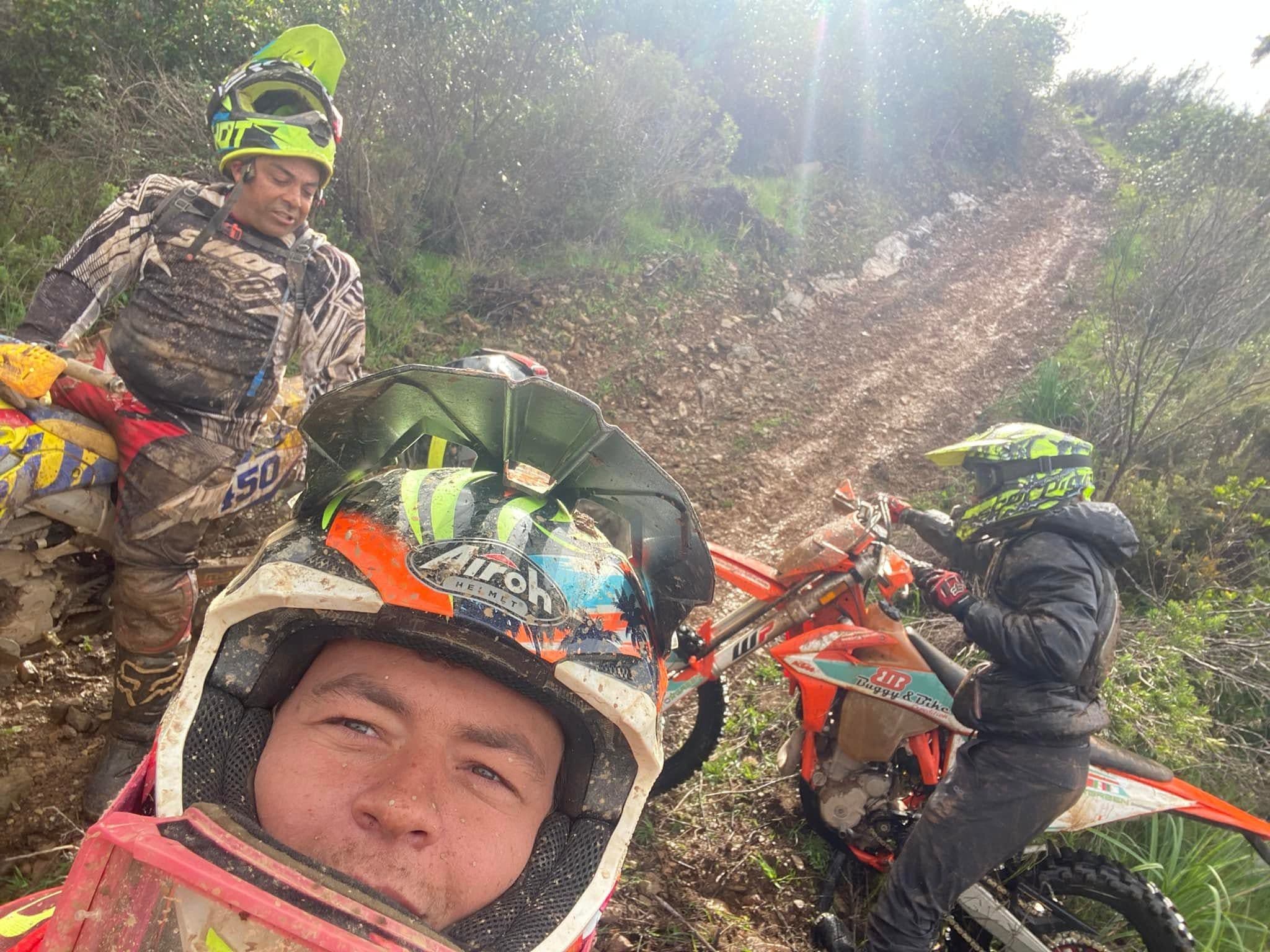 Enduro Algarve riders tackling a steep muddy trail climb together
